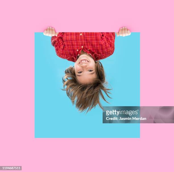 little boy looking through pink blue frame - upside down stock pictures, royalty-free photos & images