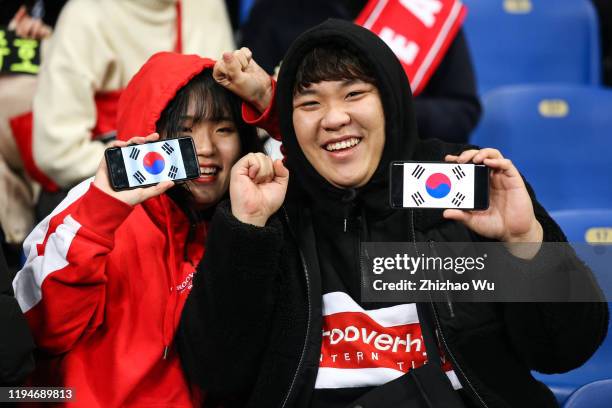 Fans of South Korea cheer during the EAFF E-1 Football Championship match between South Korea and Japan at Busan Asiad Main Stadium on December 18,...