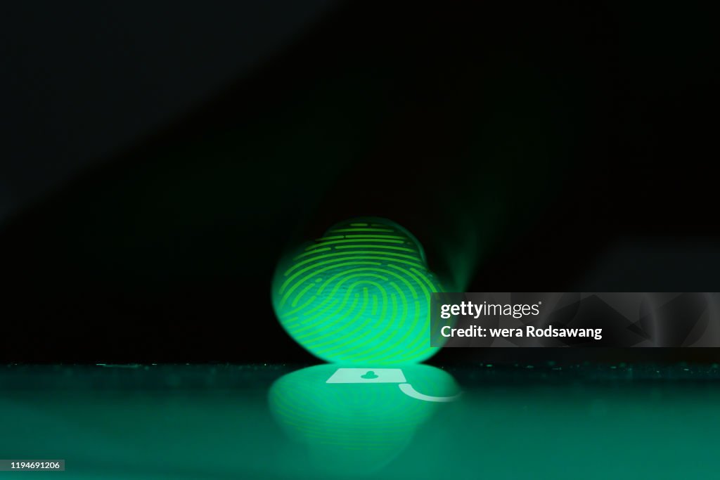 Close up photography of finger while scanning touch screen to open digital device