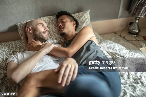 Gay Couple Enjoying In Bed During Weekend Morning High-Res Stock Photo