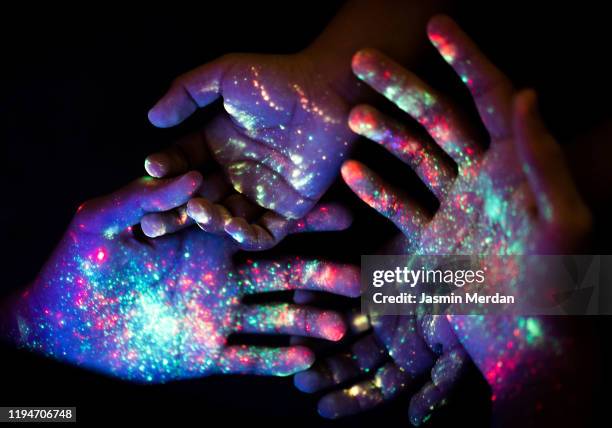 group of glowing hands together - lsd stock-fotos und bilder