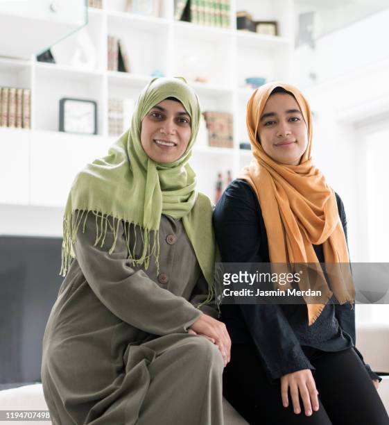 group of muslim women and girls at home - nikab stock-fotos und bilder