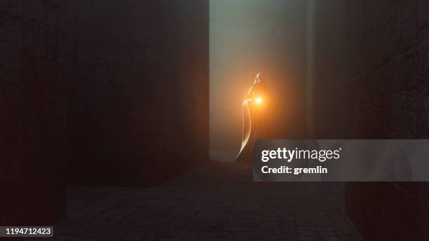 dark, hooded floating ghost statue in the castle corridors - magic stock pictures, royalty-free photos & images