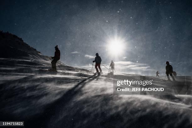 People ski in the strong wind during the 2020 Lausanne Winter Youth Olympic Games at the Leysin ski resort after the slope style contest was...