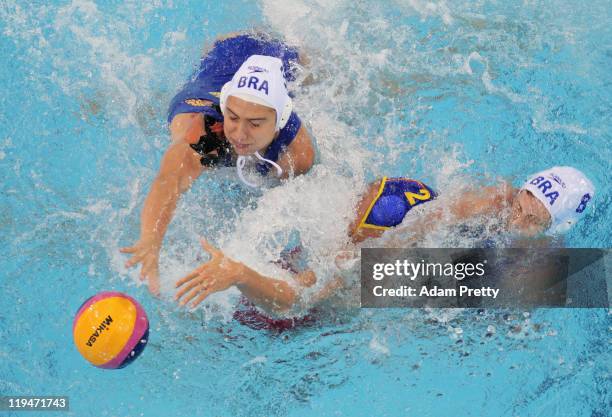 Blanca Gil Sorli of Spain battles with Marina Zablith and Luiza Carvalho of Brazil competes in the Women's Water Polo first preliminary round match...