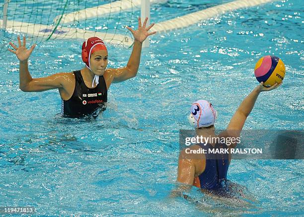 Netherlands's Frederike Jacobie and Hungary's Orsolya Kaso compete in the women's group A water polo preliminary round match against Hungary in the...