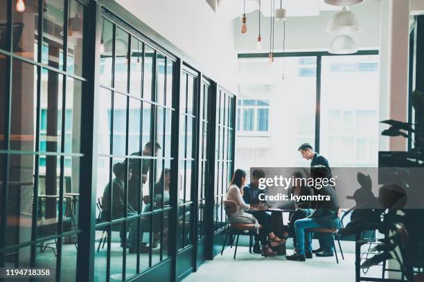 business meeting in co-working space - day planner stock pictures, royalty-free photos & images