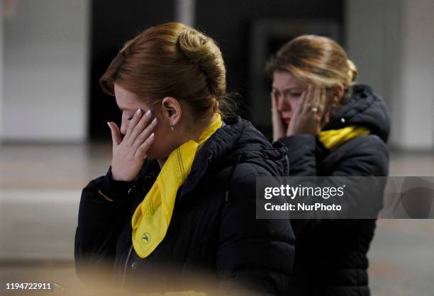 People react as coffins of 11 Ukrainians, crew members and passengers the Ukrainian 737-800 plane crash in Iran, arrive for memorial service to the...