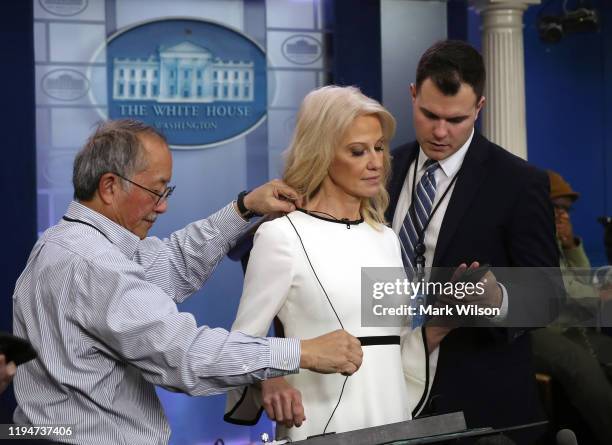 Kellyanne Conway, senior advisor to U.S. President Donald Trump, is shown an electronic device before speaking to the media in the Brady Briefing...