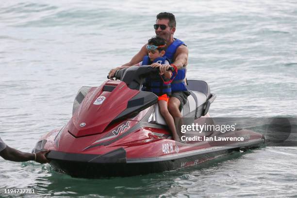 Simon Cowell is seen jet skiing with his son Eric on December 18, 2019 in Bridgetown, Barbados.