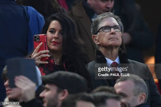 Liverpool's US owner John W. Henry and his wife Linda Pizzuti attend the English Premier League football match between Liverpool and Manchester...