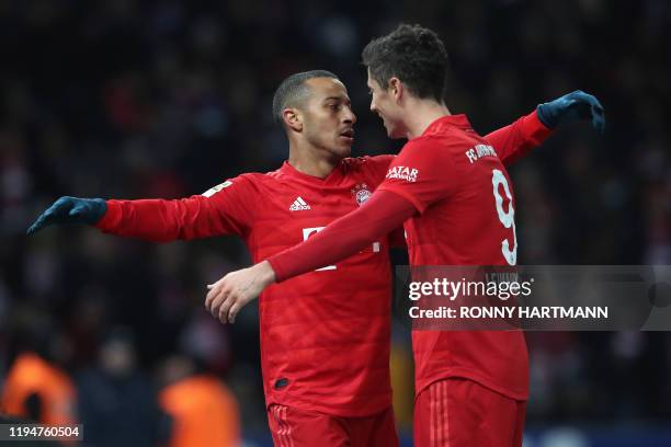 Bayern Munich's Spanish midfielder Thiago Alcantara celebrates with Bayern Munich's Polish forward Robert Lewandowski scoring during the German first...
