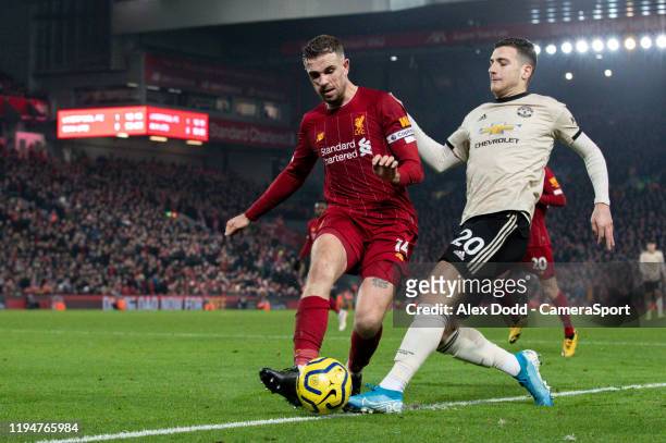 Manchester United's Diogo Dalot is tackled by Liverpool's Jordan Henderson during the Premier League match between Liverpool FC and Manchester United...