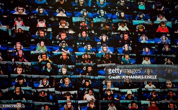 In this file photo taken on July 28, 2019 the players are seen on a TV screen during the final of the Solo competition at the 2019 Fortnite World Cup...