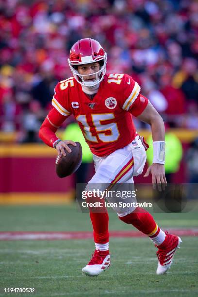 Kansas City Chiefs quarterback Patrick Mahomes scrambles in the backfield during the first half against the Tennessee Titans at Arrowhead Stadium in...