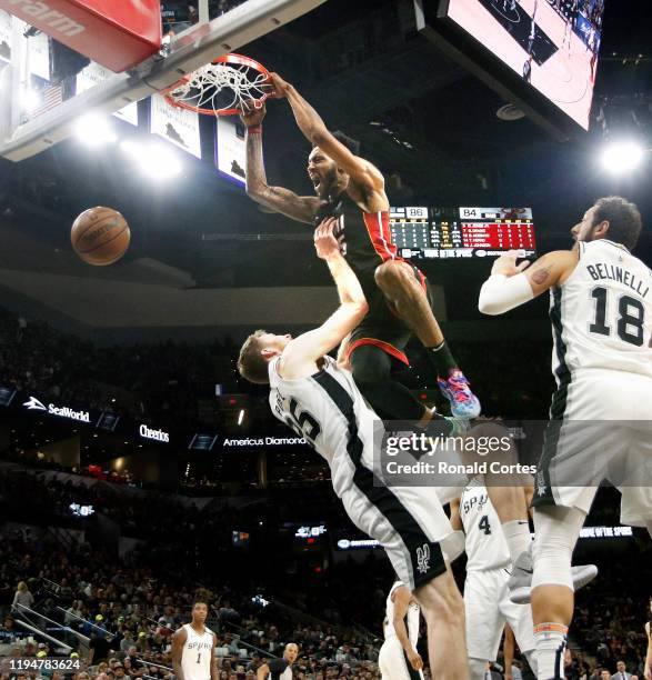 Derrick Johnson Jr. #5 of the Miami Heat dunks over Jakob Poeltl of the San Antonio Spurs during second half action at AT&T Center on January 19,...