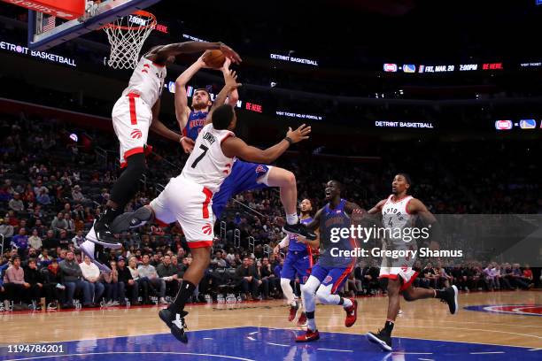 Sviatoslav Mykhailiuk of the Detroit Pistons drives to the basket against Chris Boucher and Kyle Lowry of the Toronto Raptors during the second half...