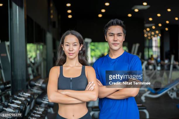 portrait of confident cheerful of beautiful physical fitness exercise instructors in gym. professional occupation and healthly lifestyle concept. - professional occupation photos et images de collection