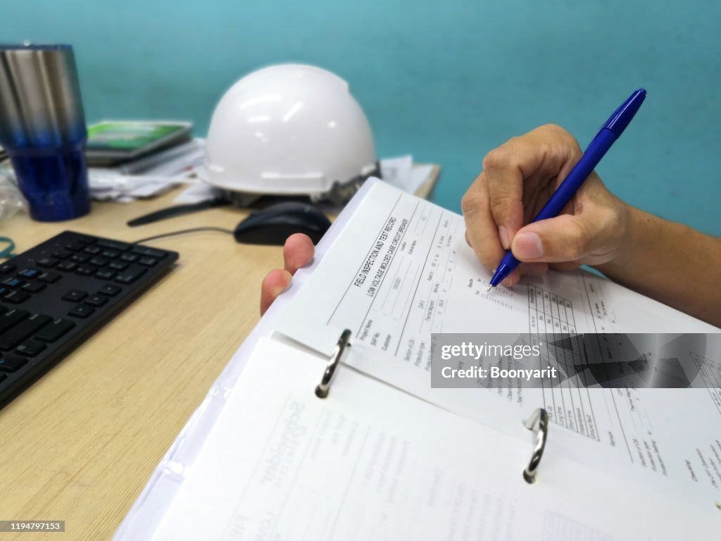 Checking Engineering Document Engineer Inspecting And Checking Datasheetengineers Check The ...