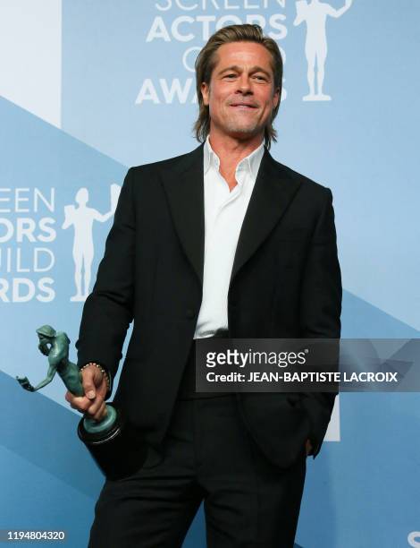 Actor Brad Pitt poses with the trophy for Outstanding Performance by a Male Actor in a Supporting Role in the press room during the 26th Annual...