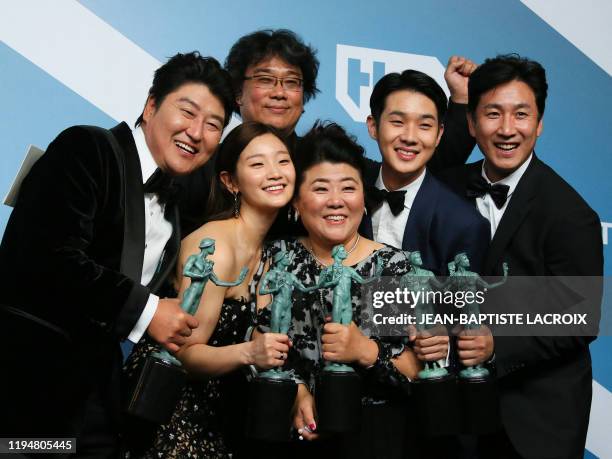 Parasite" cast Song Kang-ho, Cho Yeo-jeong, director Bong Joon-ho, Lee Jung-eun, Choi Woo-shik, and Lee Sun-kyun pose with the trophy for Outstanding...