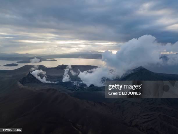 An aerial view shows the Taal volcano in Batangas province on January 20, 2020. - Decimated fish, scarred coffee plants and vanished tourists: the...