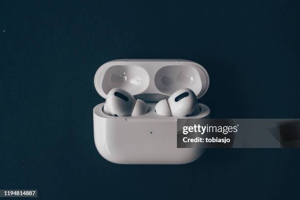 auriculares bluetooth inalámbricos apple airpods y estuche de carga - apple airpods fotografías e imágenes de stock