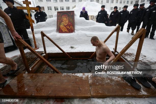Prisoners of the IK-18 prison plunge into the icy water during the celebration of the Epiphany holiday in Novosibirsk on January 19, 2020.
