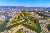 Goryokaku park in springtime cherry blossom season April and May, aerial view star shaped fort in sunny day