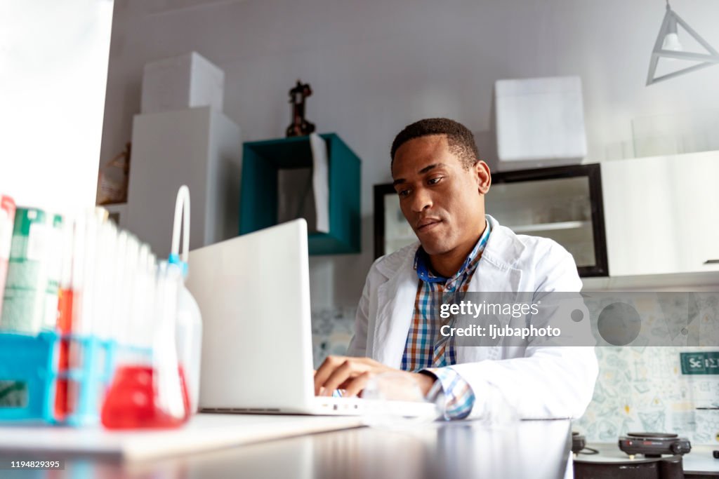 Scientist using computer in laboratory