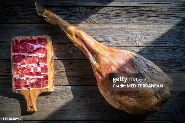 iberian ham iberic ham leg on rustic wood - iberian pig stock pictures, royalty-free photos & images