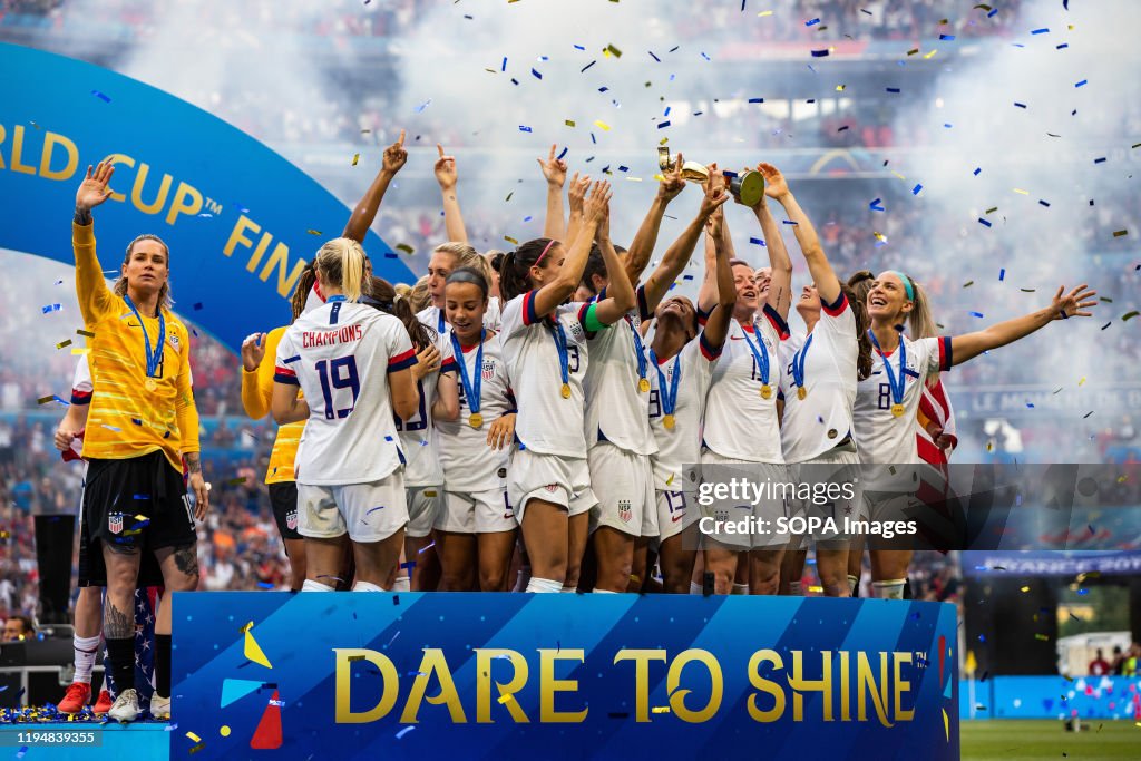 USA women's national team celebrating with trophy after the...