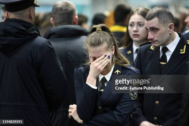 Woman reacts during the lying-in-repose ceremony for nine crew members of the Ukraine International Airlines Boeing 737-800 and two passengers killed...