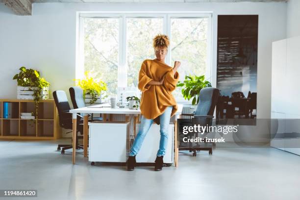 confident woman standing at startup office - hipster office stock pictures, royalty-free photos & images