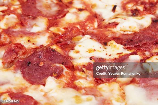 closeup of pepperoni pizza as a background - pizza crust stock pictures, royalty-free photos & images