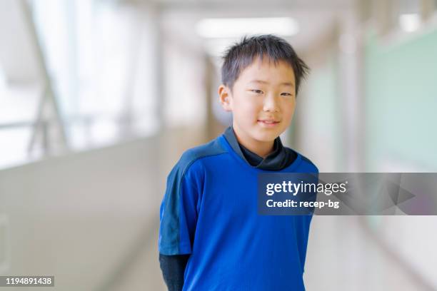 portrait of happy schoolboy in hallways - japanese boys stock pictures, royalty-free photos & images