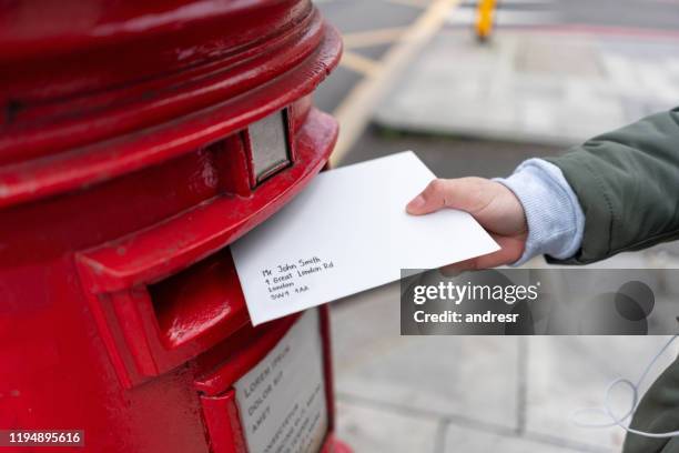 close-up on a woman sending a letter by mail - message sent stock pictures, royalty-free photos & images