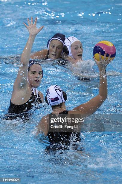 Lauren Jane Sieprath of New Zealand is challenged by Katrina Monton of Canada in the Women's Water Polo first preliminary round match between New...