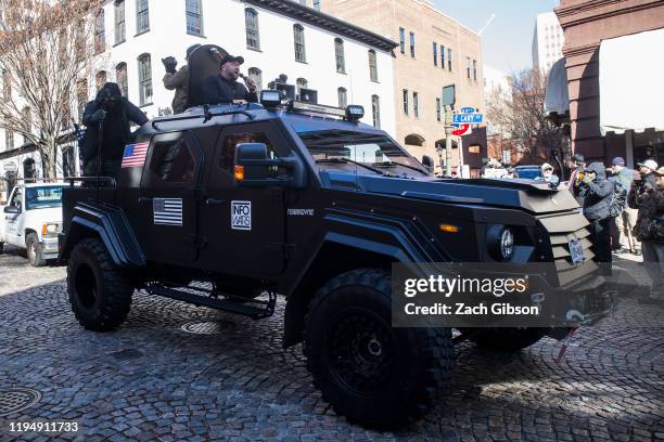 InfoWars host Alex Jones rides in an armored vehicle during a rally organized by The Virginia Citizens Defense League on Capitol Square near the...