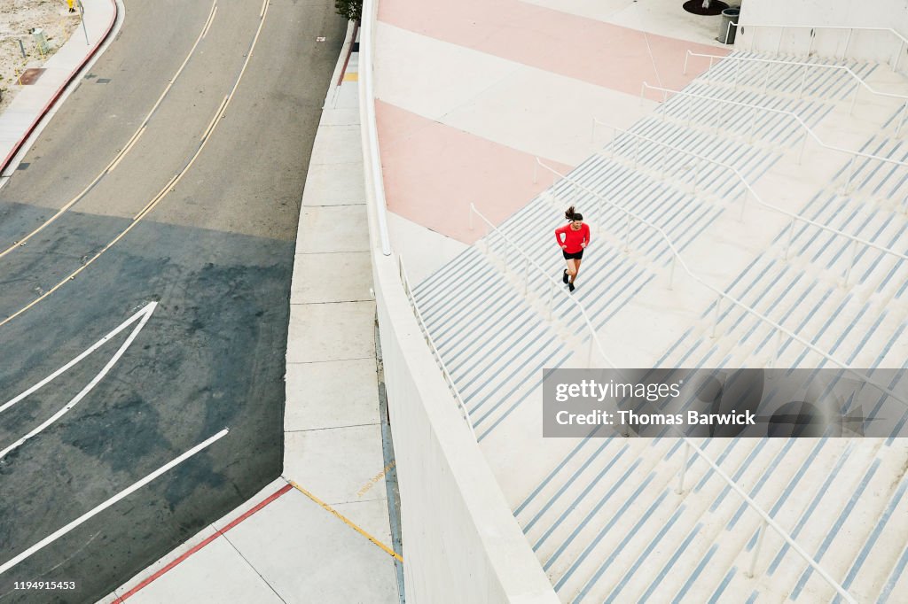 Overhead view of mature woman running stairs during workout