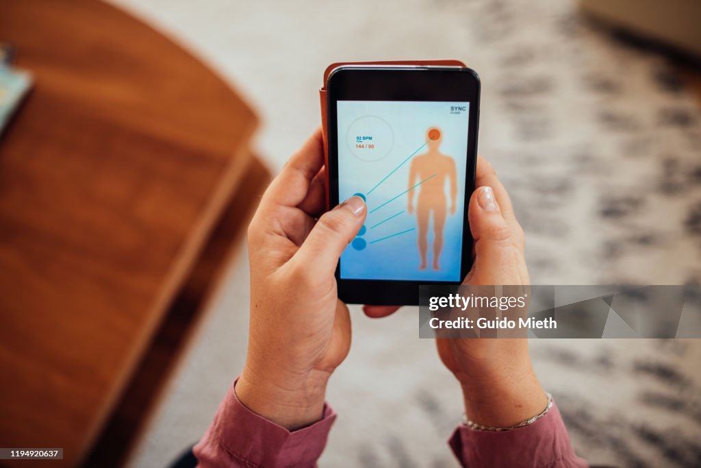 Woman checking mobile health app.