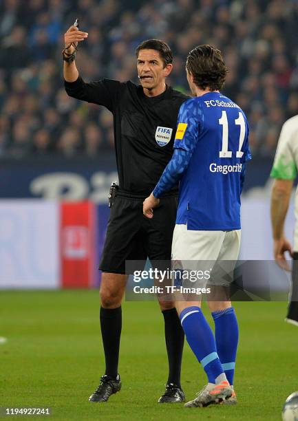 Referee Deniz Aytekin and Michael Gregoritsch of FC Schalke 04 gestures during the Bundesliga match between FC Schalke 04 and Borussia...