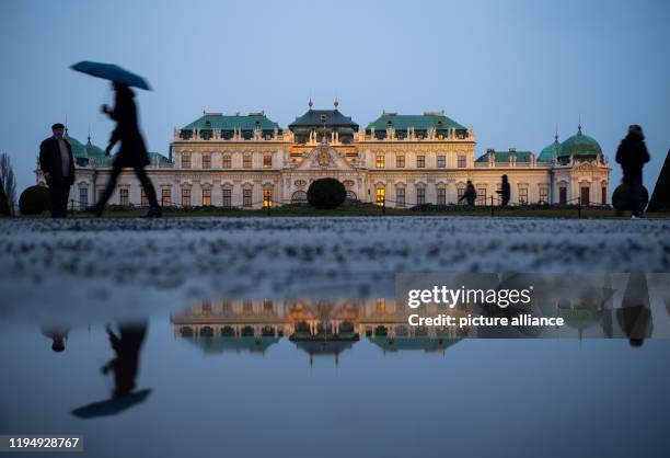 January 2020, Austria, Wien: In the evening, the Belvedere Palace is reflected in a puddle in the baroque gardens. Photo: Robert...