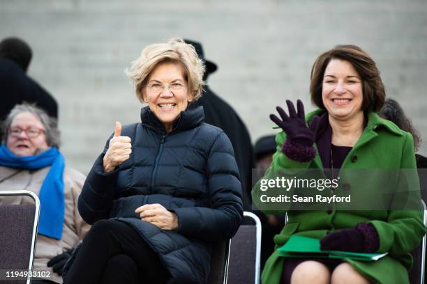 Democratic presidential candidates, Sen. Elizabeth Warren , left, and Sen. Amy Klobuchar gesture to the crowd during the King Day at the Dome rally...