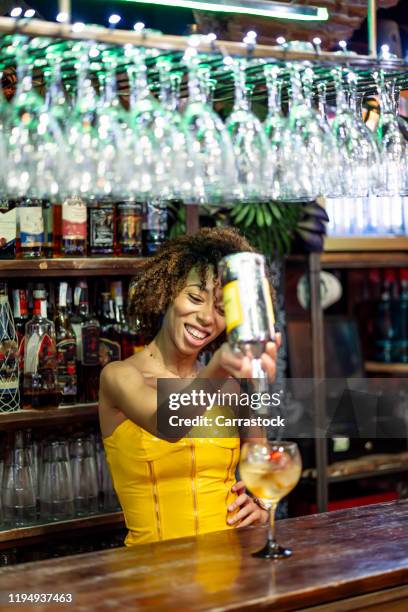 beautiful afro woman working in nightclub. - barman tequila stock-fotos und bilder