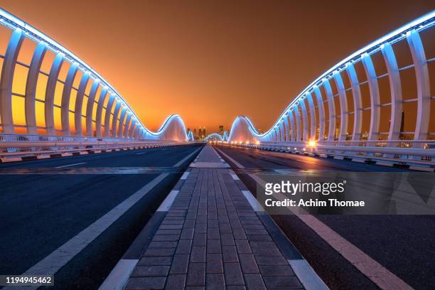 meydan bridge; dubai, united arab emirates - dubai water canal stock pictures, royalty-free photos & images