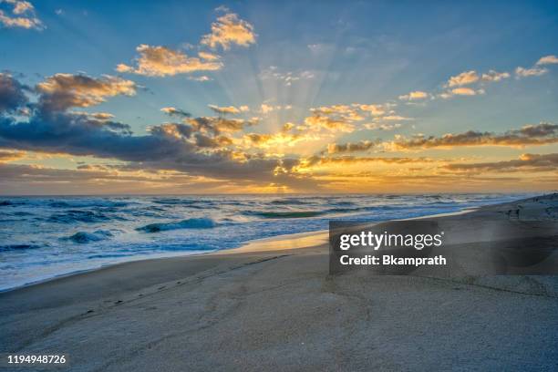 beautiful sunrise on the beach over the atlantic ocean on merritt island national wildlife refuge florida - beach sunrise stock pictures, royalty-free photos & images