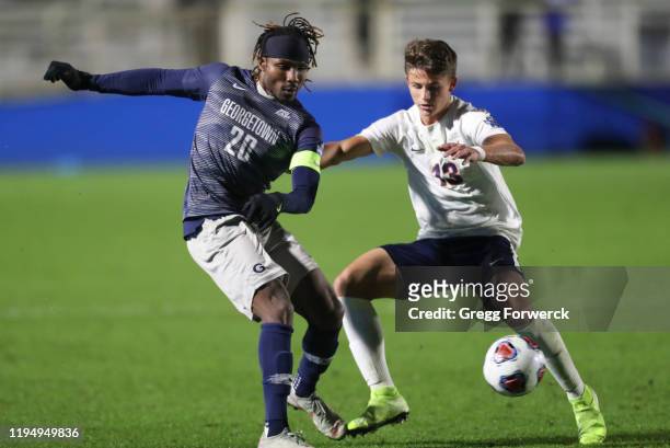 Achara of the Georgetown Hoyas and Bret Halsey of the Virginia Cavaliers compete for the ball during the Division I Men's Soccer Championship held at...