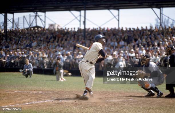 Hank Aaron of the Milwaukee Braves swings and misses the pitch during an MLB Spring Training game against the New York Yankees circa March, 1958 in...