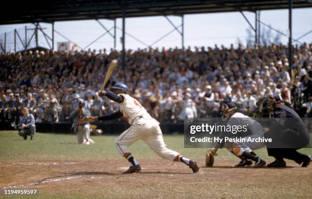 Hank Aaron of the Milwaukee Braves swings at the pitch during an MLB Spring Training game against the New York Yankees circa March, 1958 in...